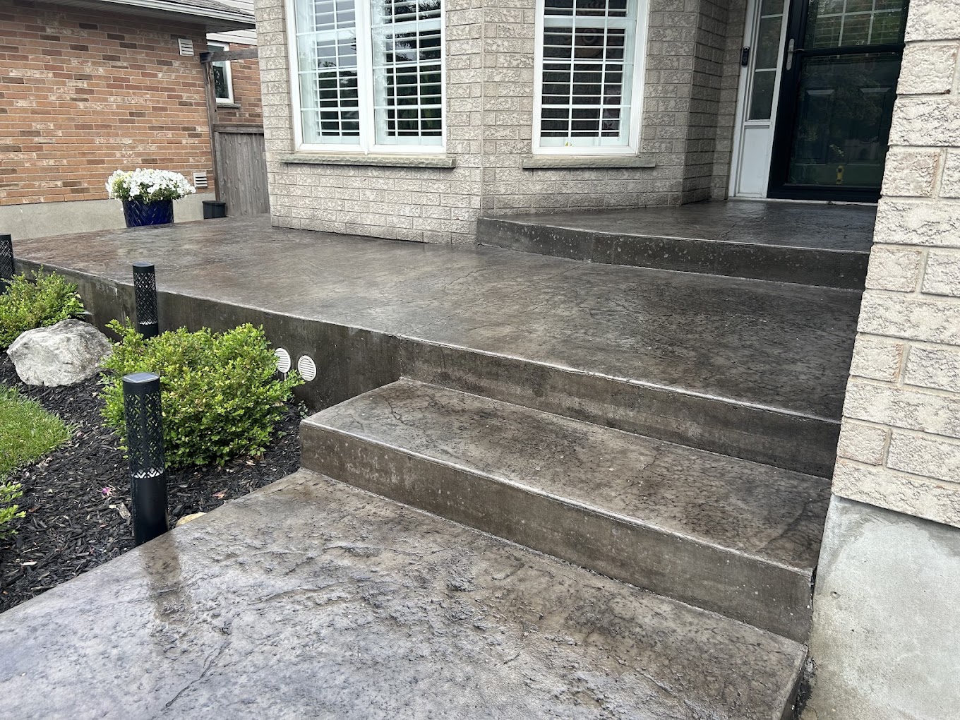 Stamped concrete front porch and wide steps in a slate grey finish